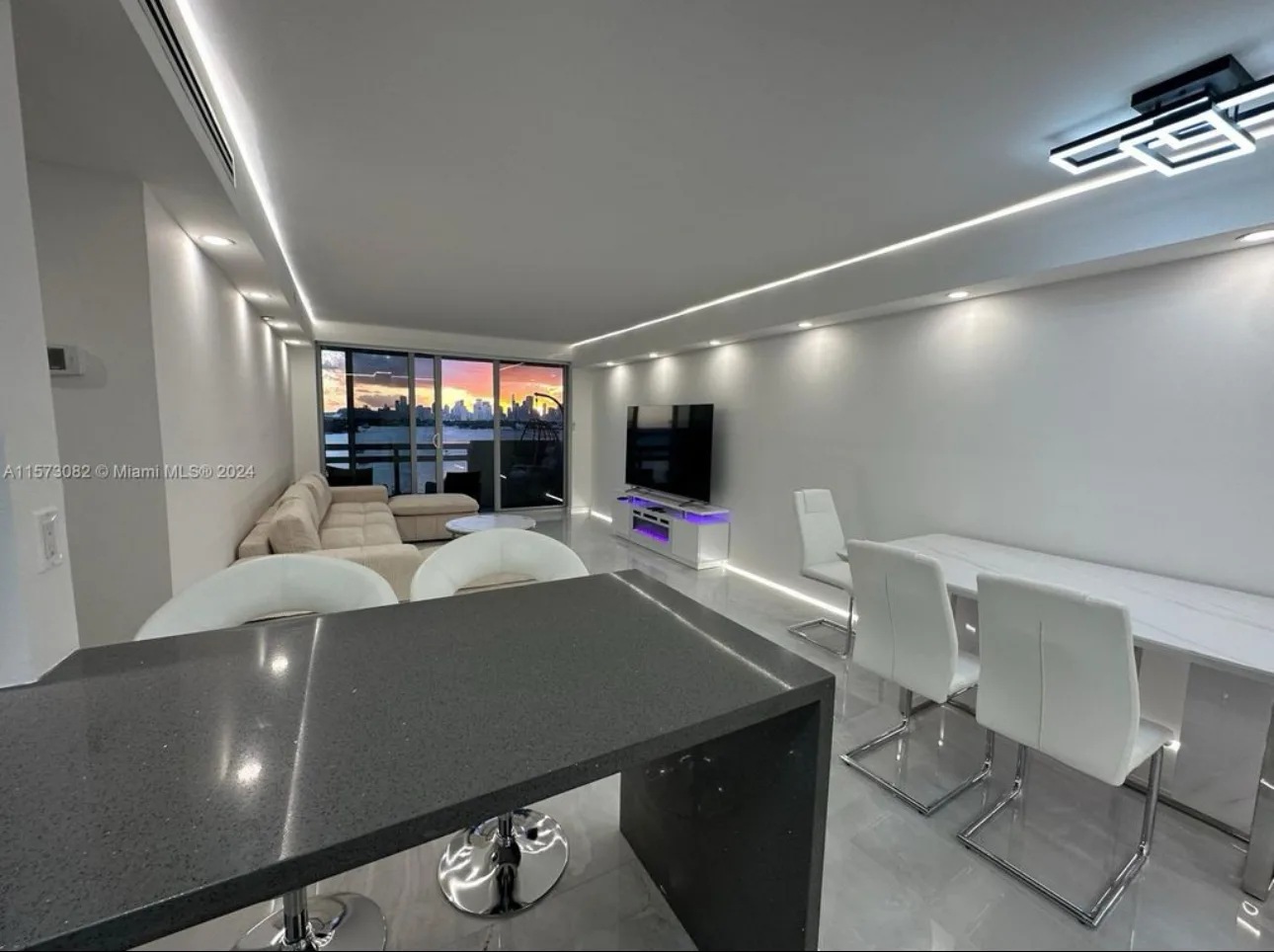Open plan living and dining area with LED lighting