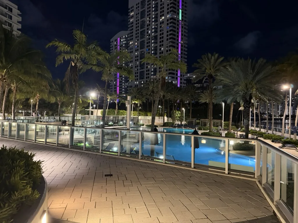 Flamingo Point pool illuminated at night with city skyline